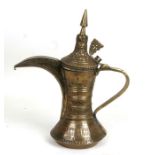 A Turkish / Islamic brass Dallah coffee pot, 33cms (13ins) high.
