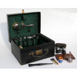 A gentleman's fitted vanity case with silver topped bottles, brushes etc.