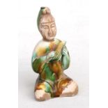 A Chinese sancai glazed figure of a seated musician, 15cms (6ins) high.