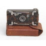 A brass cased Houghton's Ltd 'Ensignette' folding bellows camera in original leather case, 10cms (