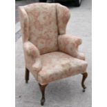 A wingback armchair on cabriole front supports