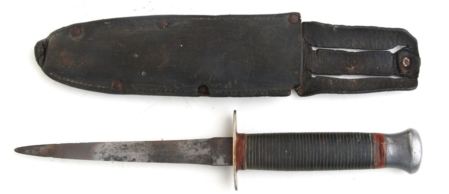 A William Rogers / Sykes Fairburn style Commando dagger in a leather sheath, 27.5cms (10.5ins)