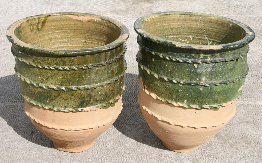 A pair of large half glazed Turkish pottery planters, 62cms (24.5ins) high (2).