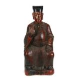 A large Chinese carved wooden lacquer and gilded figure depicting a seated dignitary, 56cms (