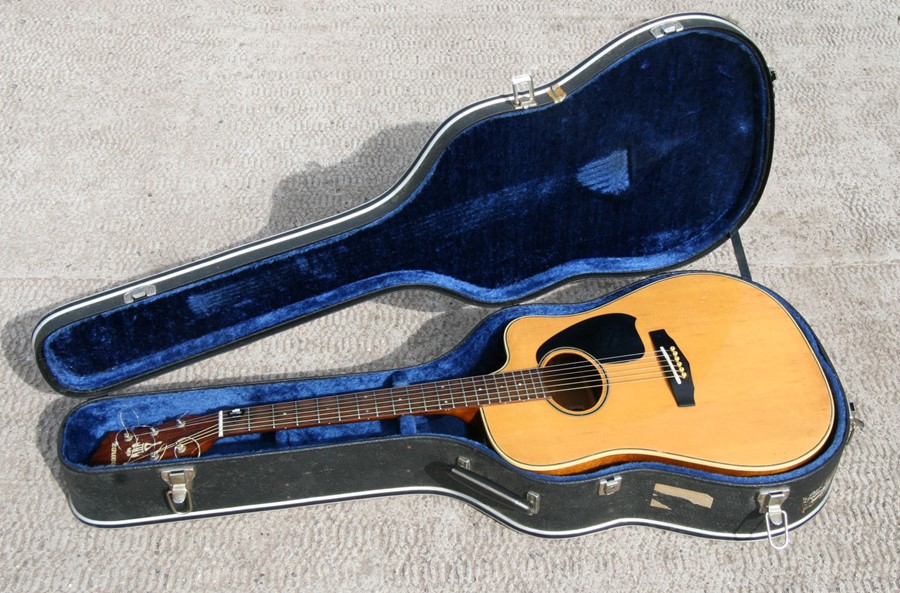 A vintage Ibanez AE300 Electro Acoustic guitar in a Fender hard case.