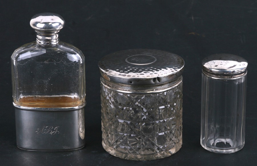 A silver & cut glass hip flask, London 1898, and two silver topped dressing table jars (3)