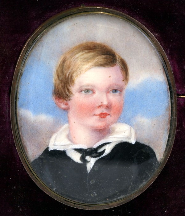 A portrait miniature depicting a young boy, mounted as a brooch in its original shaped and fitted