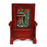 A Chinese cinnabar lacquer table screen with inset rectangular porcelain panel depicting figures,