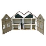 A large 1930's two storey wooden doll's house, 137cms (54ins) wide.