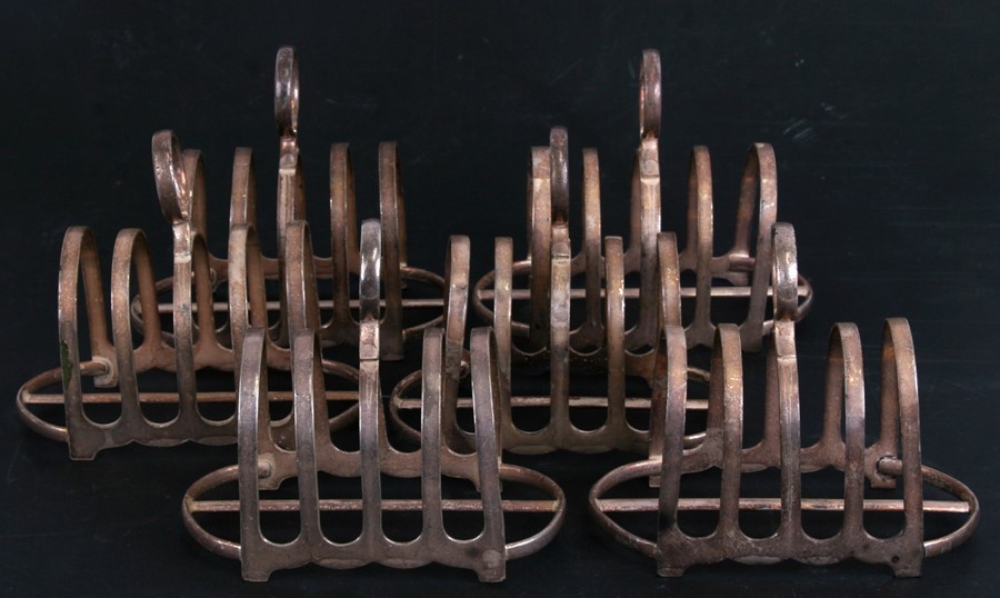 A set of six War Dept. silver plated four division toast racks, the base impressed with Crow's Foot,