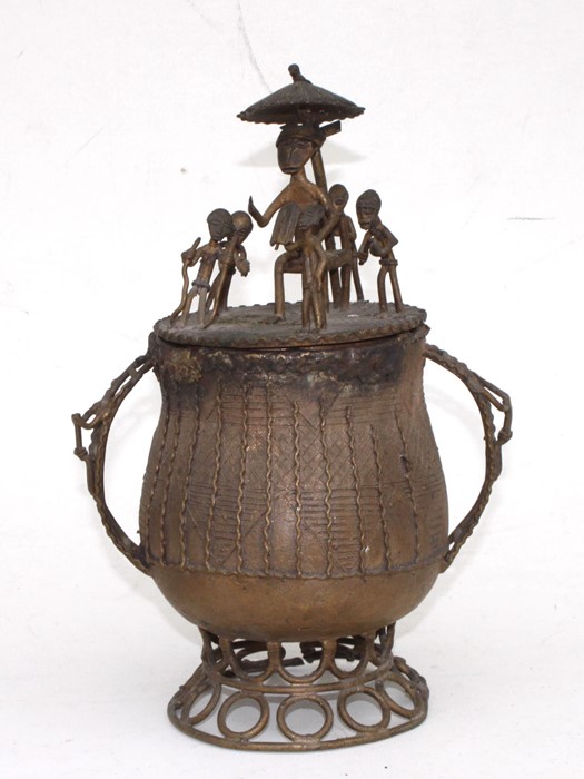 An African tribal bronze urn and cover surmounted with figures, 27cms 910.5ins) high.