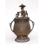 An African tribal bronze urn and cover surmounted with figures, 27cms 910.5ins) high.