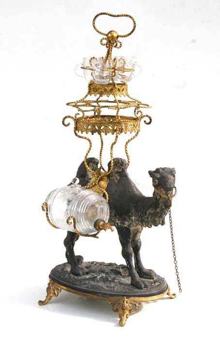 A late 19th century gilt metal and spelter liquor stand modelled as a camel with gilt metal saddle