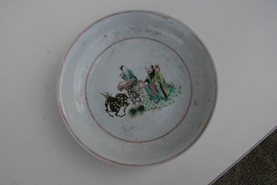 A Chinese famille rose charger depicting a scholar with scrolls beside a scribe and a deer, 30cms ( - Image 4 of 4