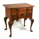 An 18th century style walnut lowboy with an arrangement of four drawers, on cabriole legs, 75cms (