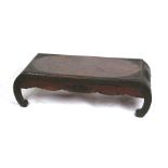 A Chinese hardwood low table with carved decoration, 104cms (41ins) wide.