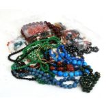 A quantity of costume jewellery to include necklaces and beads.