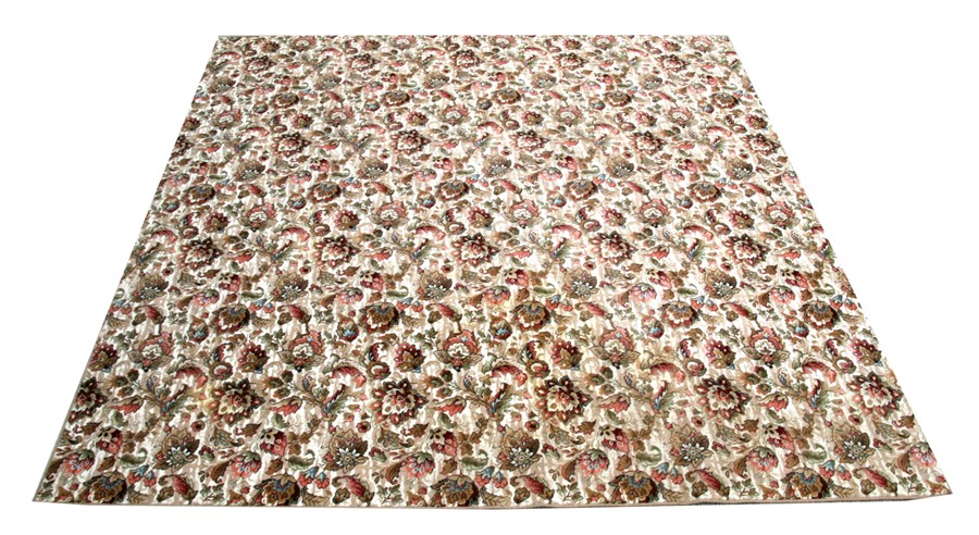 A large persian style carpet with foliate scrolls on a beige ground