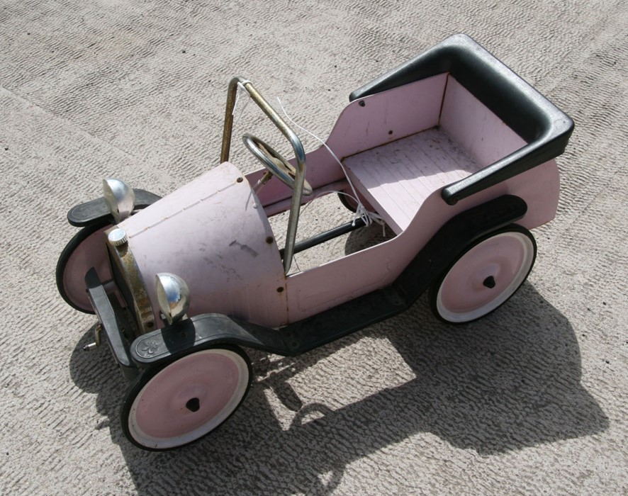 A child's pedal car in the form of an Edwardian motor car.