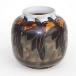 A Royal Doulton stoneware vase decorated with fruit and leaves, incised initials 'BN' to the