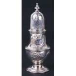 A large silver pepper caster, London 1744 and makers mark for James Wilks. 14cm (5.5 ins) high.