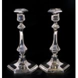 A matched pair of Victorian silver candlesticks with slender baluster form columns, on stepped