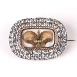 An early 19th century white and yellow metal mourning brooch, the central panel with hair work