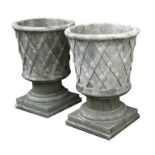 A pair of reconstituted stone urns of classical form, each 46cms (18ins) diameter (2).