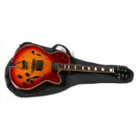A Manito semi acoustic guitar with two Humbucker pick ups and Sunburst finish, with soft carrying