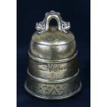 A Tibetan brass temple bell with cypher decoration, 6.75ins high and 5.8ins wide max.