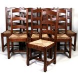 A set of eight oak ladderback dining chairs with rush drop-in seats (8).