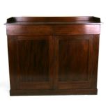 A Victorian side cabinet with two frieze drawers above a pair of panelled doors, on a plinth base,