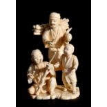 A 19th century Japanese ivory figural group depicting a woodsman and children, 15cms (6ins) high.