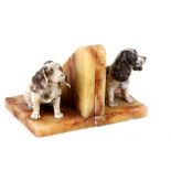 A pair of Art Deco spelter and alabaster dog bookends, circa 1930, in the form of seated spaniels,