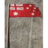 An early 20th century printed cotton Australian Red Ensign flag a/f attached to a pole. The flag