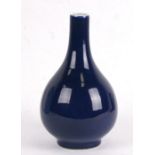 A Chinese blue glazed bottle vase with six character blue mark to the underside, 24cms (9.5ins)