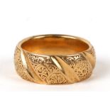 An 18ct gold wedding band with engraved foliate decoration. Approx. UK size N. 12.4gCondition