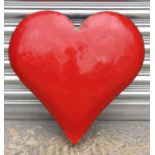 A red enamel & aluminium wall hanging in the form of a heart, 52cms (20.5ins) wide.