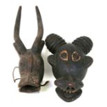An African tribal mask in the form of an antelope; together with another in the form of a stylised