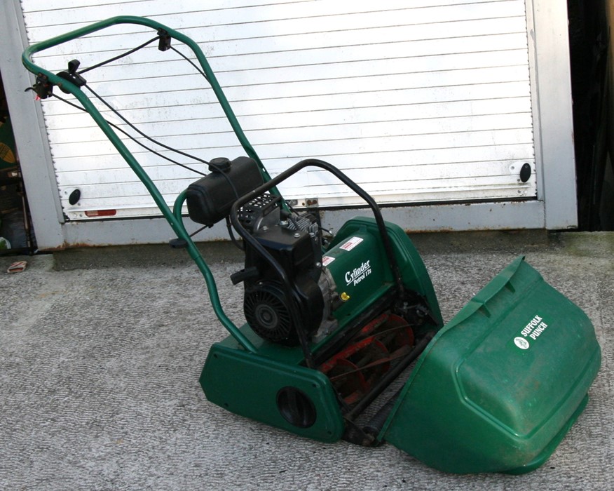 A Suffolk Punch petrol cylinder mower with 40cms (16ins) cut, instructions and original bill of sale