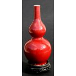 A Chinese red glazed double gourd vase with six character mark to the underside, 24cms (9.5ins)