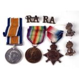 A WW1 Royal Artillery medal trio with associated badges, the 1915 Star is named to 60754 Gunner G.