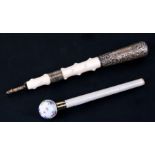 A large Victorian silver and ivory walking stick handle together with a porcelain floral ball