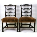 A pair of Georgian mahogany chairs on square chamfered reeded front supports.