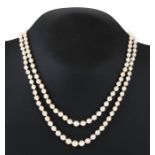 A double strand pearl necklace with diamond set white metal clasp.39cm (15.25 ins) long