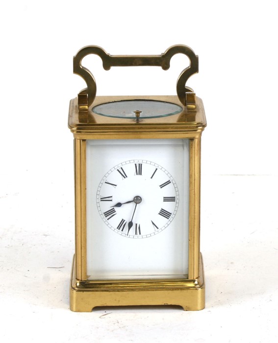 A brass cased repeater carriage clock, the white enamel dial with Roman numerals, the movement