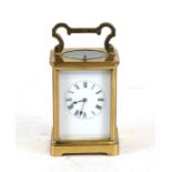 A brass cased repeater carriage clock, the white enamel dial with Roman numerals, the movement