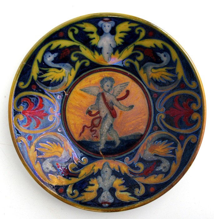 A maiolica dish decorated with a central winged cherub, 23cms (9ins) diameter (a/f).Condition