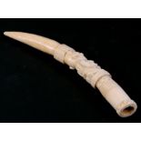 An early 20th century African ivory tusk, possibly Loango, carved with a central kneeling figure