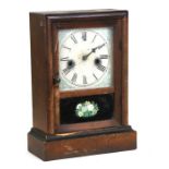 A late 19th century Waterbury Clock Co. mantle clock, the white painted dial with Roman numerals,